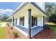 Exterior view of a covered front porch supported by columns and complemented by manicured landscaping at 107 Sugarpine Pl, Summerville, SC 29486