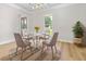 Dining room with stylish light fixture, table, rug and large windows at 107 Sugarpine Pl, Summerville, SC 29486