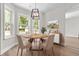 Dining room with stylish light fixture, table, and large windows at 107 Sugarpine Pl, Summerville, SC 29486