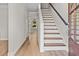 Inviting entryway featuring a wooden front door, staircase and light wood flooring at 107 Sugarpine Pl, Summerville, SC 29486
