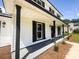Two-story home featuring a long front porch and black window shutters at 107 Sugarpine Pl, Summerville, SC 29486