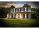 Charming two-story home featuring a covered front porch, dark shutters, and a lush green lawn at 107 Sugarpine Pl, Summerville, SC 29486