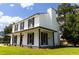 Side view of a two-story home featuring a chimney and a covered porch on a sunny day at 107 Sugarpine Pl, Summerville, SC 29486