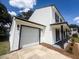 Exterior view showcasing a two-story home with a large white garage door at 107 Sugarpine Pl, Summerville, SC 29486