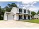 Charming two-story home featuring a covered porch and attached garage on a sunny day at 107 Sugarpine Pl, Summerville, SC 29486