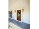 Inviting front porch with a dark wood front door and decorative lanterns at 107 Sugarpine Pl, Summerville, SC 29486