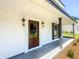 Inviting front porch with a dark wood front door with sidelights at 107 Sugarpine Pl, Summerville, SC 29486