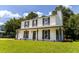 Two-story home with a covered porch, an attached garage and a well-manicured lawn on a sunny day at 107 Sugarpine Pl, Summerville, SC 29486