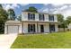 Inviting front yard with lush green grass leading to a two-story home with a covered porch at 107 Sugarpine Pl, Summerville, SC 29486