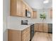 Well-lit kitchen features white countertops, herringbone backsplash, and light wood cabinets at 107 Sugarpine Pl, Summerville, SC 29486