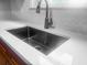 Close-up of a modern kitchen sink with a stainless steel faucet and white countertop at 107 Sugarpine Pl, Summerville, SC 29486