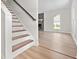 Bright living room featuring stairs, stone fireplace, and hardwood floors at 107 Sugarpine Pl, Summerville, SC 29486