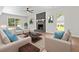 Bright and airy living room furnished with modern furniture and a stone fireplace at 107 Sugarpine Pl, Summerville, SC 29486