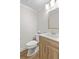 Cozy powder room with modern vanity, white countertop, and a wood grain cabinet at 107 Sugarpine Pl, Summerville, SC 29486