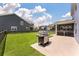 Grill and patio area with a view of the lush green fenced in backyard and screened porch at 109 Goose Rd, Summerville, SC 29483