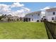 Expansive backyard with a lush lawn, wood fence for privacy, and a patio with a grill at 109 Goose Rd, Summerville, SC 29483