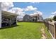 Fenced backyard with lush green grass and a screened-in porch providing an outdoor living space at 109 Goose Rd, Summerville, SC 29483