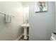 Half-bathroom featuring a pedestal sink, stylish mirror, and a decorative floral painting at 109 Goose Rd, Summerville, SC 29483