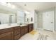 Bright bathroom with double sink vanity, white cabinets, modern fixtures, and a large mirror at 109 Goose Rd, Summerville, SC 29483