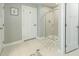 Neutral toned bathroom featuring a glass door shower with white and tan tiling and floors at 109 Goose Rd, Summerville, SC 29483