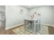 Bright dining space with a wooden table, four chairs, and a decorative rug for an inviting atmosphere at 109 Goose Rd, Summerville, SC 29483