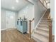 Inviting foyer with hardwood floors, staircase, and a blue accent cabinet for a modern feel at 109 Goose Rd, Summerville, SC 29483