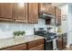 Well-lit kitchen features stainless steel appliances, granite countertops, and sleek wood cabinetry at 109 Goose Rd, Summerville, SC 29483