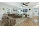 Spacious living room features a sectional couch, ceiling fan, and natural light for a comfortable ambiance at 109 Goose Rd, Summerville, SC 29483