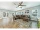 Large living area with a plush sectional sofa, hardwood floors, and French doors leading to the backyard at 109 Goose Rd, Summerville, SC 29483