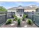 Landscaped backyard with a grilling area, screened-in porch, mature landscaping, and a dark wood fence at 1100 Griswold St, Mount Pleasant, SC 29466