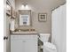 A well-lit bathroom with a decorative mirror, a white vanity, and modern fixtures at 1100 Griswold St, Mount Pleasant, SC 29466