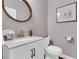 Stylish powder room featuring a modern vanity, round mirror, elegant wallpaper, and refined fixtures at 1100 Griswold St, Mount Pleasant, SC 29466