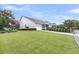 Well-maintained home with lush green lawn, vibrant flowering tree, and spacious driveway, offering suburban charm at 1100 Griswold St, Mount Pleasant, SC 29466