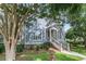 Inviting home exterior with a welcoming porch, lush landscaping, and an American flag, exuding patriotic charm at 1100 Griswold St, Mount Pleasant, SC 29466