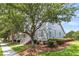 Charming street view of a cozy home with well-maintained landscaping, mature trees, and inviting curb appeal at 1100 Griswold St, Mount Pleasant, SC 29466