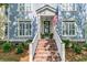 Close-up of the home's entrance, highlighting brick steps, a decorated door, and an American flag at 1100 Griswold St, Mount Pleasant, SC 29466