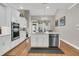 Bright kitchen featuring white cabinets, stainless steel appliances, and a large island with a sink and dishwasher at 1100 Griswold St, Mount Pleasant, SC 29466