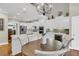 Open kitchen with stainless steel appliances, white cabinets, island with seating, and adjacent dining area at 1100 Griswold St, Mount Pleasant, SC 29466