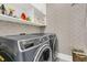 Efficient laundry room with modern washer and dryer set, complemented by ample shelving and storage space at 1100 Griswold St, Mount Pleasant, SC 29466