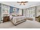 Spacious main bedroom with large windows, plantation shutters, sitting area and ceiling fan at 1100 Griswold St, Mount Pleasant, SC 29466