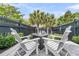 Relaxing patio featuring a modern fire pit, comfortable Adirondack chairs, and lush landscaping for outdoor enjoyment at 1100 Griswold St, Mount Pleasant, SC 29466