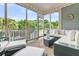 Inviting screened porch with comfortable seating, overhead lighting, and views of the surrounding greenery at 1100 Griswold St, Mount Pleasant, SC 29466