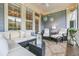 Cozy screened porch with comfortable seating, decorative lighting, and a peaceful ambiance at 1100 Griswold St, Mount Pleasant, SC 29466