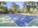 A full-size tennis court with tall shade trees behind the fence is great for a friendly game of tennis at 1100 Griswold St, Mount Pleasant, SC 29466