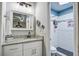 Bathroom with white cabinets, gray granite counter tops, and a view of the shower at 1126 Brigantine Dr, Charleston, SC 29412