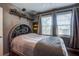 Bedroom featuring a unique arched headboard, stylish gray bedding, and windows with natural light at 1126 Brigantine Dr, Charleston, SC 29412