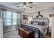 Cozy bedroom with a black metal bed frame, a wooden chest, a ceiling fan, and lots of natural light at 1126 Brigantine Dr, Charleston, SC 29412