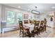 Inviting dining room with a long table, decorative lighting fixture and large windows with natural light at 1126 Brigantine Dr, Charleston, SC 29412