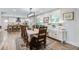 Open dining area with a view of the kitchen, features a large window and stylish sideboard with decorative elements at 1126 Brigantine Dr, Charleston, SC 29412