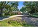 Home exterior with driveway, chimney, landscaping, and outdoor swing set at 1126 Brigantine Dr, Charleston, SC 29412